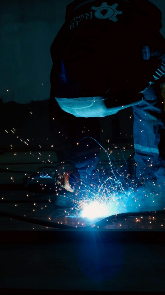 Welder working on creating parts