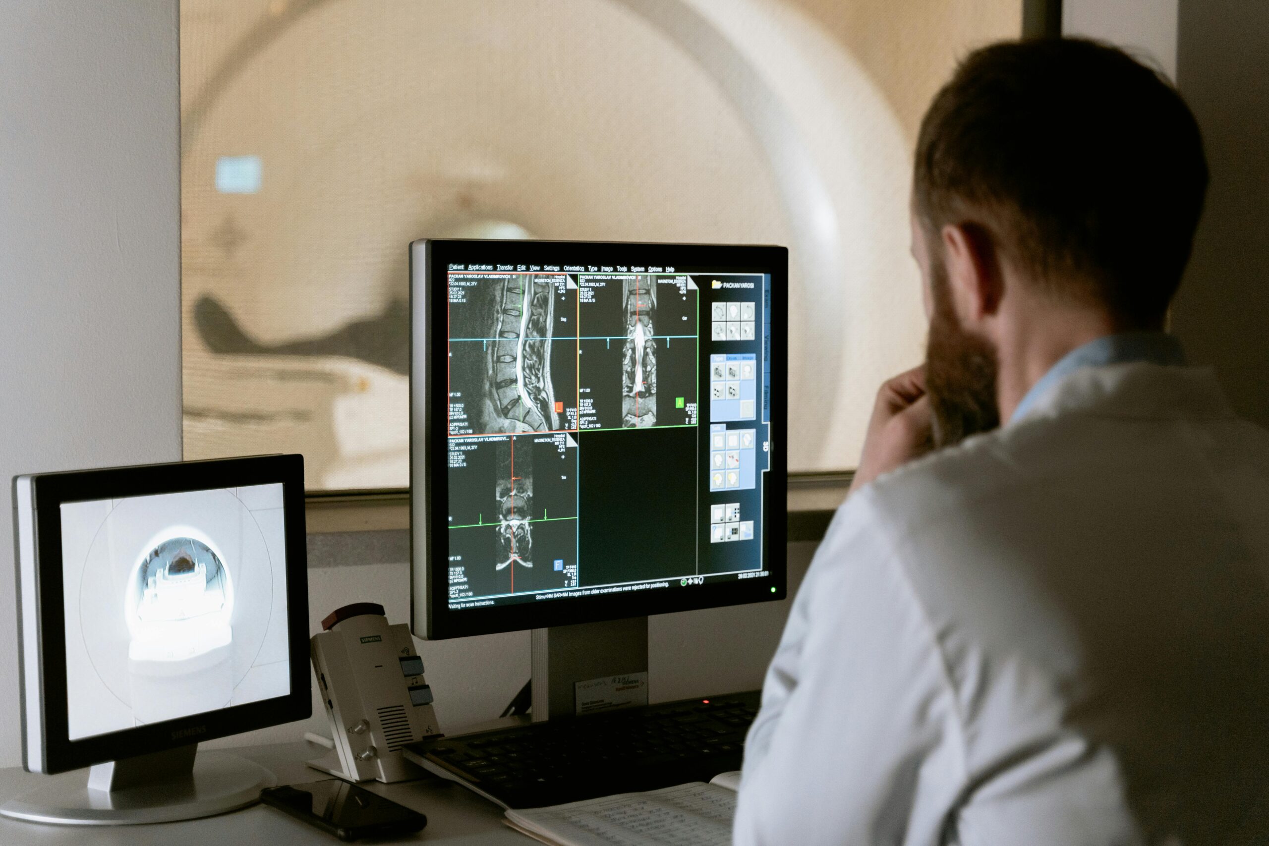 Doctor examining CT scan from a separate room